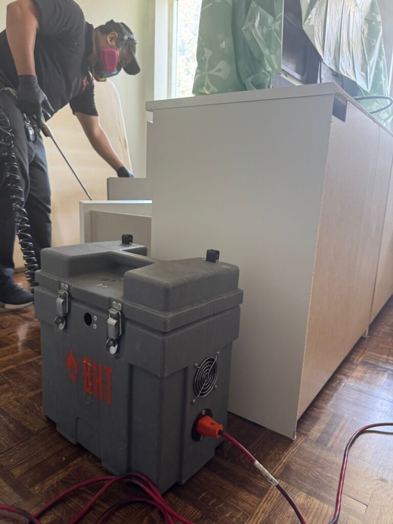 Technician setting up heat treatment equipment for a bed bug job