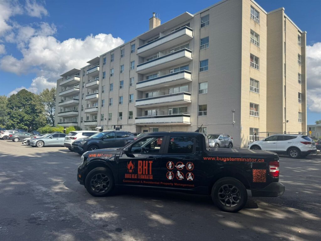Bugs Heat Terminator branded truck parked outside a Toronto apartment building